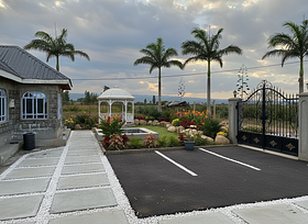 A gate should be at the corner of the area, 5 parking slots and a gazebo and 4  royal palm trees