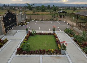 A gate at the corner a 5 Parking slots and 3 royal palm trees and 2 water fountains 
