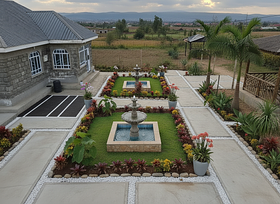 2 water fountains, and 2 parking slots  3 royal palm trees. 