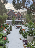 Winter season: A winter landscaping design for this space and house. Cone trees along the path an...