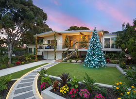 Symmetrical Trees: Place two tall (8-10 ft), slender, potted artificial Christmas trees on the se...