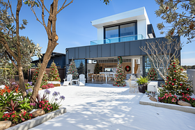 Generate a winter season of merry Christmas trees landscaping design for this space and house day...